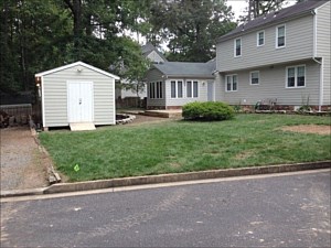 Paver Patios, Walkways, Steps, Retaining Wall, Seating Wall, Firepit and Berm with Plantings: Before