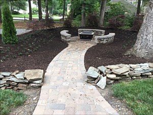 Project #2 – Circle Patio, Walkways, Fire pit, Seat Walls, Berm (Planted with – Dwarf Red Maples, Emerald Green Arborvitaes, Dwarf Mondo Grass), Mulch, Split Rail Fence